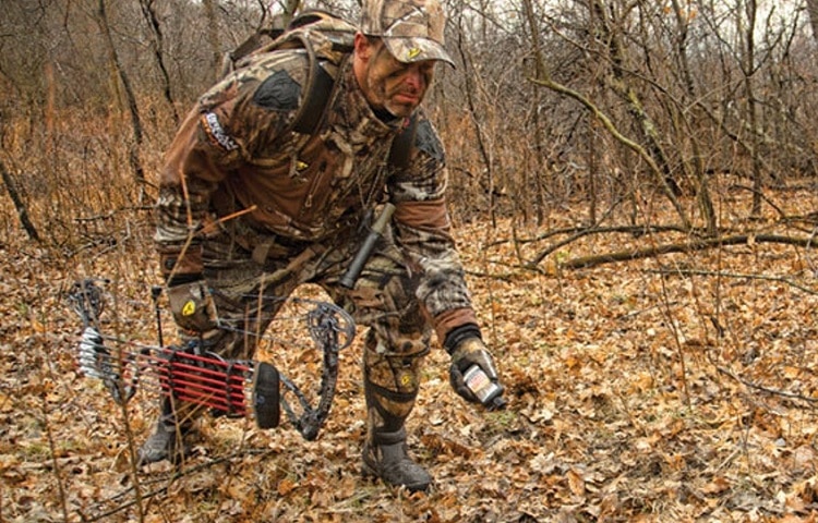 hunter spraying deer scent